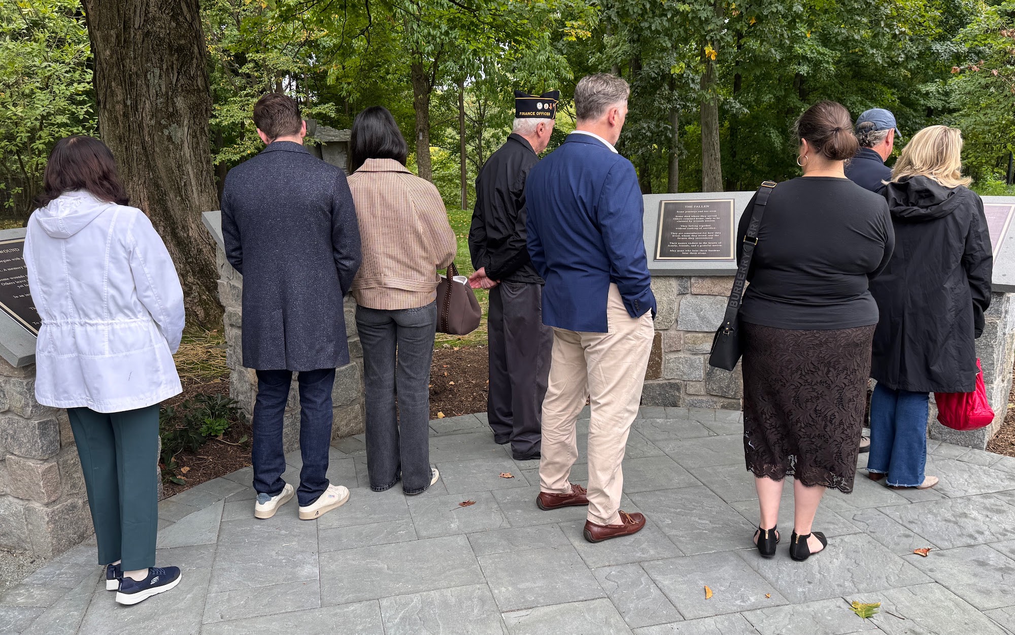 Guests reflecting at the bronze memorial plaques